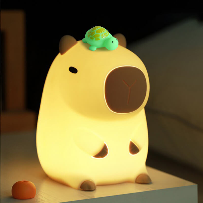 Cute animal-shaped night light with a turtle on its back, glowing softly.